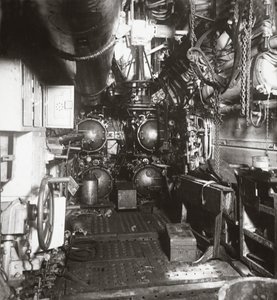 Interior of forward compartment of U-boat 135 showing torpedo and four torpedo tubes by English Photographer